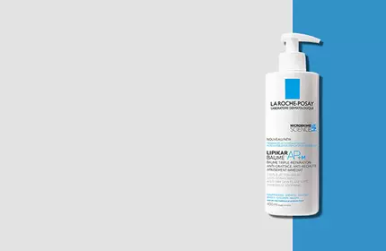 A bottle of La Roche-Posay cleanser with a pump dispenser, set against a light grey background with a blue stripe.