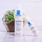 A close-up of La Roche-Posay Toleriane skincare products, featuring a cleanser and moisturizer, placed next to a small green plant in a decorative container.