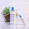 A flat lay of two La Roche-Posay Toleriane skincare products: a cleanser and a moisturizer, displayed next to a small potted plant in a geometric pot.