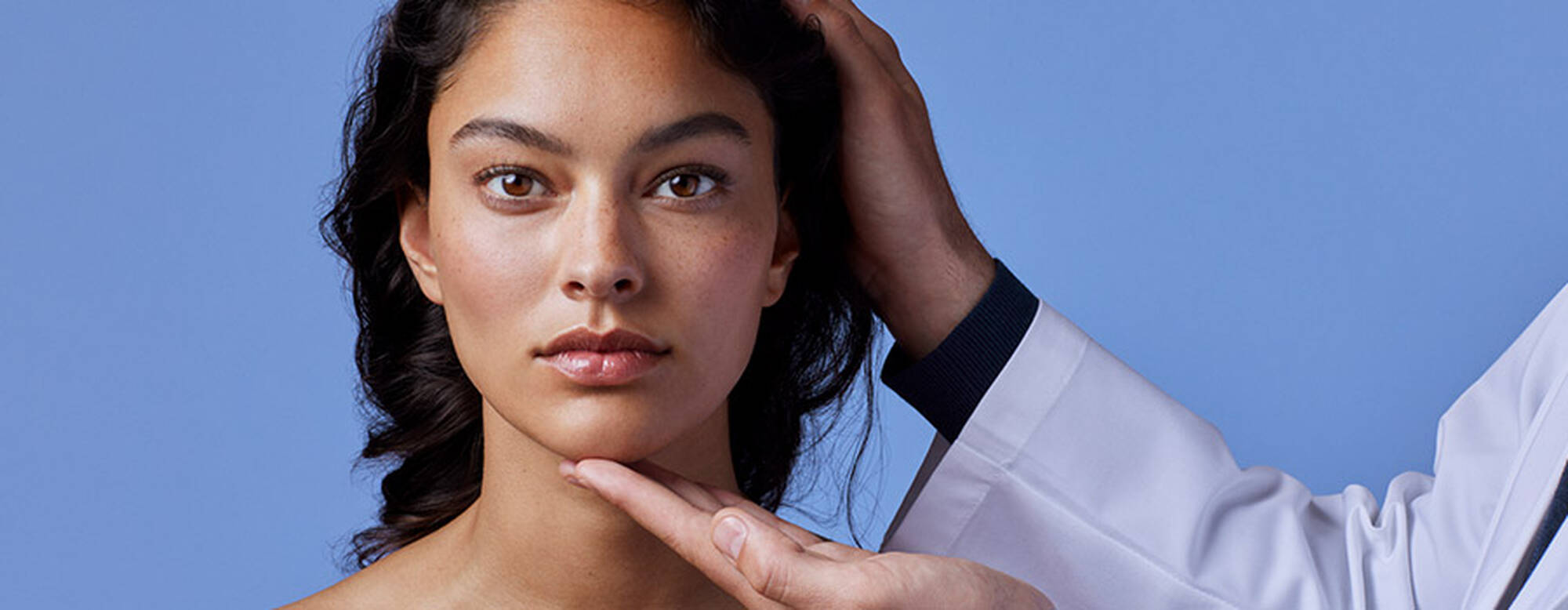 Person examining skin texture and pigmentation, illustrating the role of melanin in skin colour