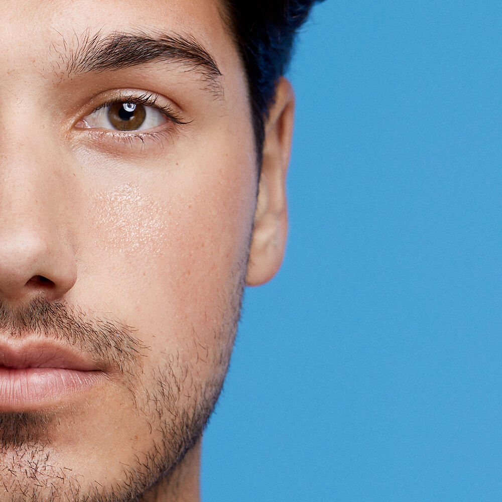 Half of a man’s face, with clear skin