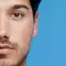 Half of a man’s face, with clear skin