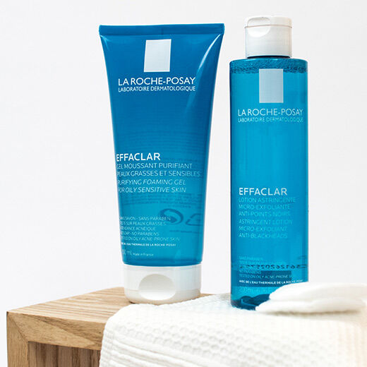 Two skincare products displayed: a blue tube labeled "Effaclar Purifying Foaming Gel" and a blue bottle labeled "Effaclar Astringent Lotion," both from La Roche-Posay, designed for oily and sensitive skin.