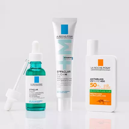 Three skincare products from La Roche-Posay: a blue serum in a dropper bottle, a tube of Effaclar Duo+M cream, and a bottle of Anthelios sunscreen with SPF 50+.