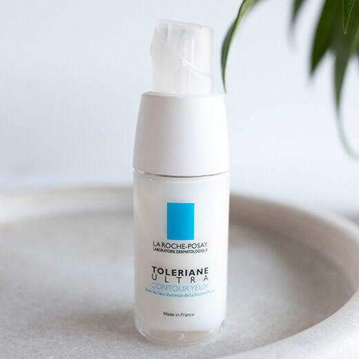 A white skincare bottle of La Roche-Posay's Toleriane Ultra Contour Yeux, featuring a simple blue logo on the front.
