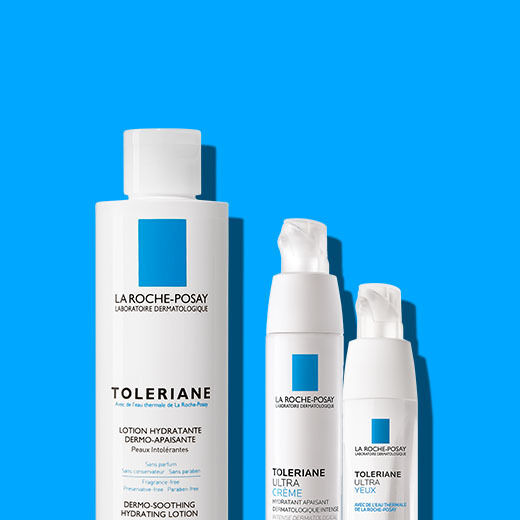 Alt text: A collection of three La Roche-Posay Toleriane skincare products on a bright blue background, including a hydrating lotion and two cream bottles.