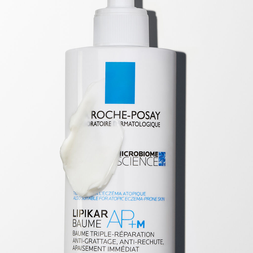 A tube of La Roche-Posay Lipikar AP+M Balm, featuring a sleek design with a blue logo and white background, promoting skin care for atopic and eczema-prone skin.