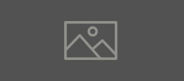 Icon depicting a simple landscape with two mountains and a sun, set against a dark background.