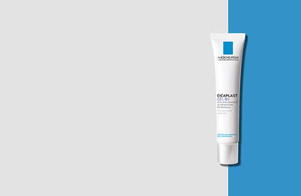A white tube of skincare cream with blue accents, displayed against a light gray and blue background.