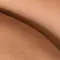 Close-up of two gently curved, smooth skin areas overlapping each other.