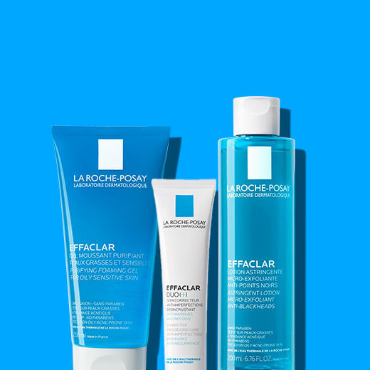 Three skincare products from La Roche-Posay: a foaming cleanser, a dual-action treatment, and a toner, displayed against a bright blue background.