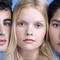 A close-up portrait of three individuals with various features, arranged side by side against a light blue background. They have neutral expressions and are looking directly at the camera, showcasing their diverse appearances.