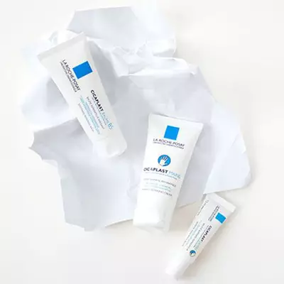 Three tubes of La Roche-Posay skincare products displayed on crumpled white paper.