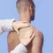 A healthcare professional's hand examining the shoulder of a patient against a light blue background.