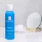 A blue bottle of La Roche-Posay Serozinc, a zinc sulfate solution for oily, blemish-prone skin, is displayed beside a small mirror and cotton pads.
