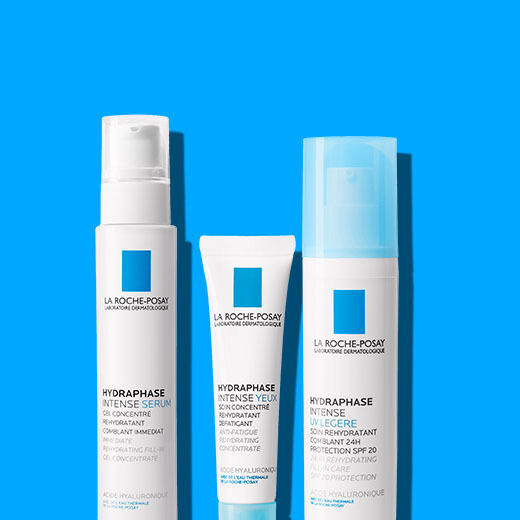 Three skincare products from La Roche-Posay are displayed against a bright blue background. The products include a serum, an eye cream, and a moisturizer, all designed for hydration.