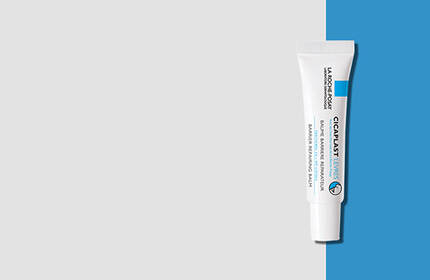A tube of skincare cream against a light gray background with a blue accent.