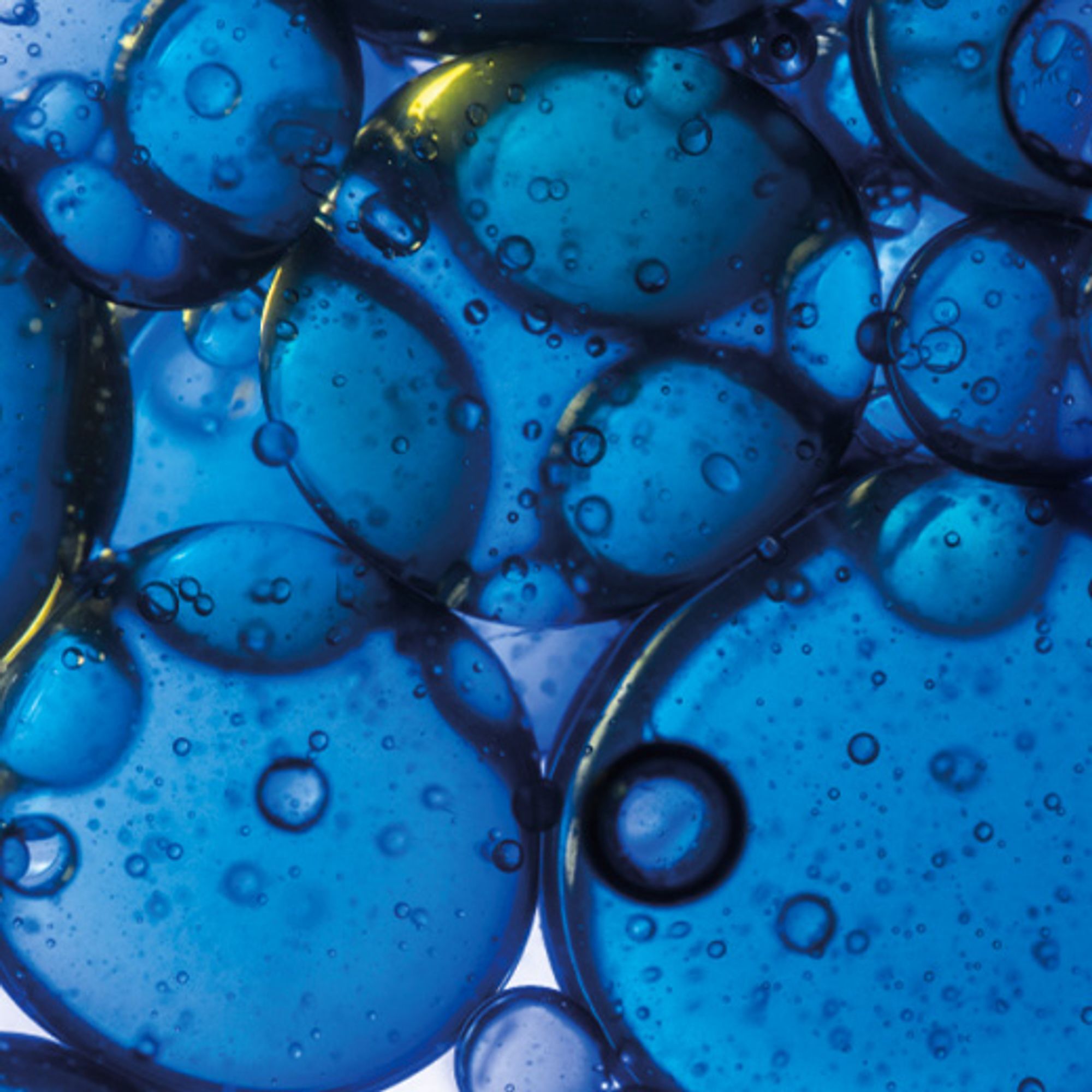 A close up of a skincare ingredient, which is dark blue in colour and bubbly