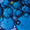 A close up of a skincare ingredient, which is dark blue in colour and bubbly