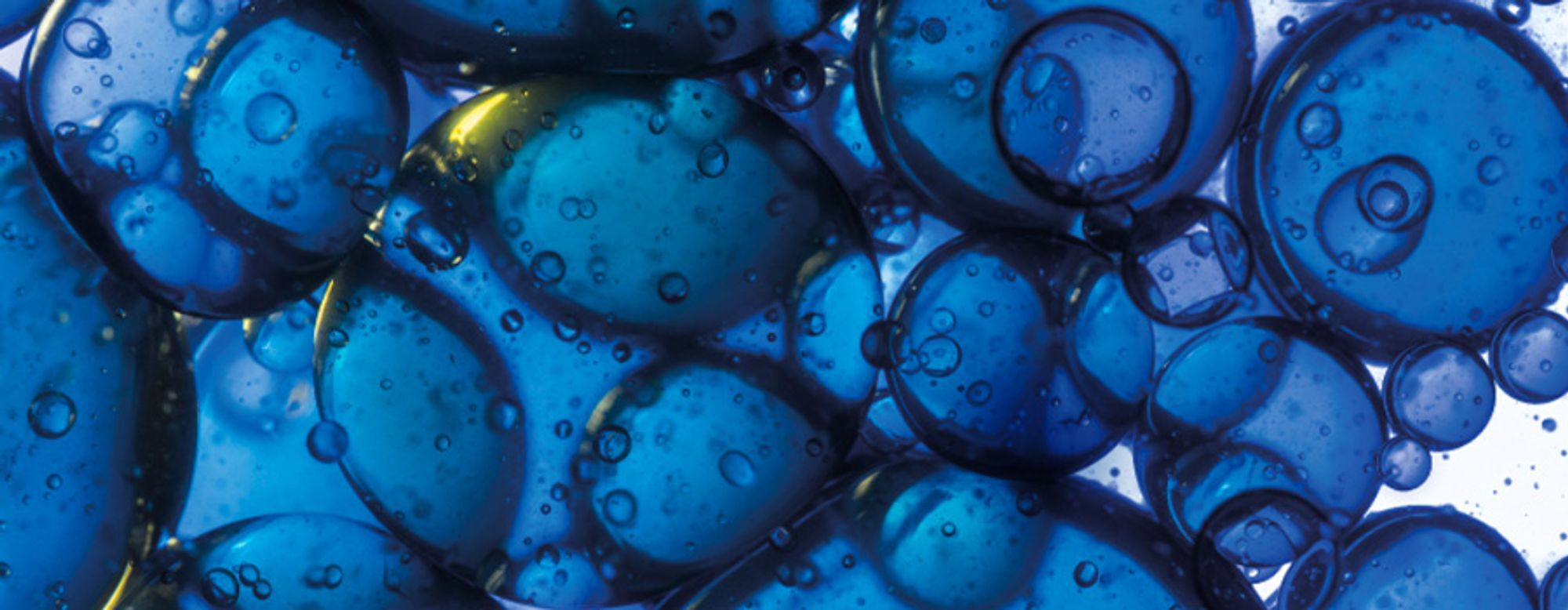 A bottle of La Roche-Posay Effaclar gel, featuring a turquoise design with the brand's logo and product name prominently displayed, surrounded by small bubbles and droplets.