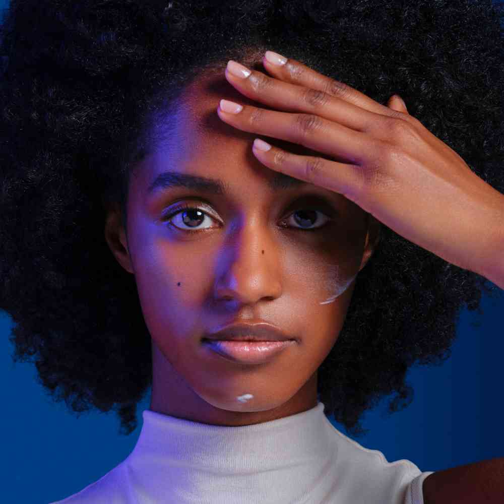 Woman with radiant skin applying Mela B3