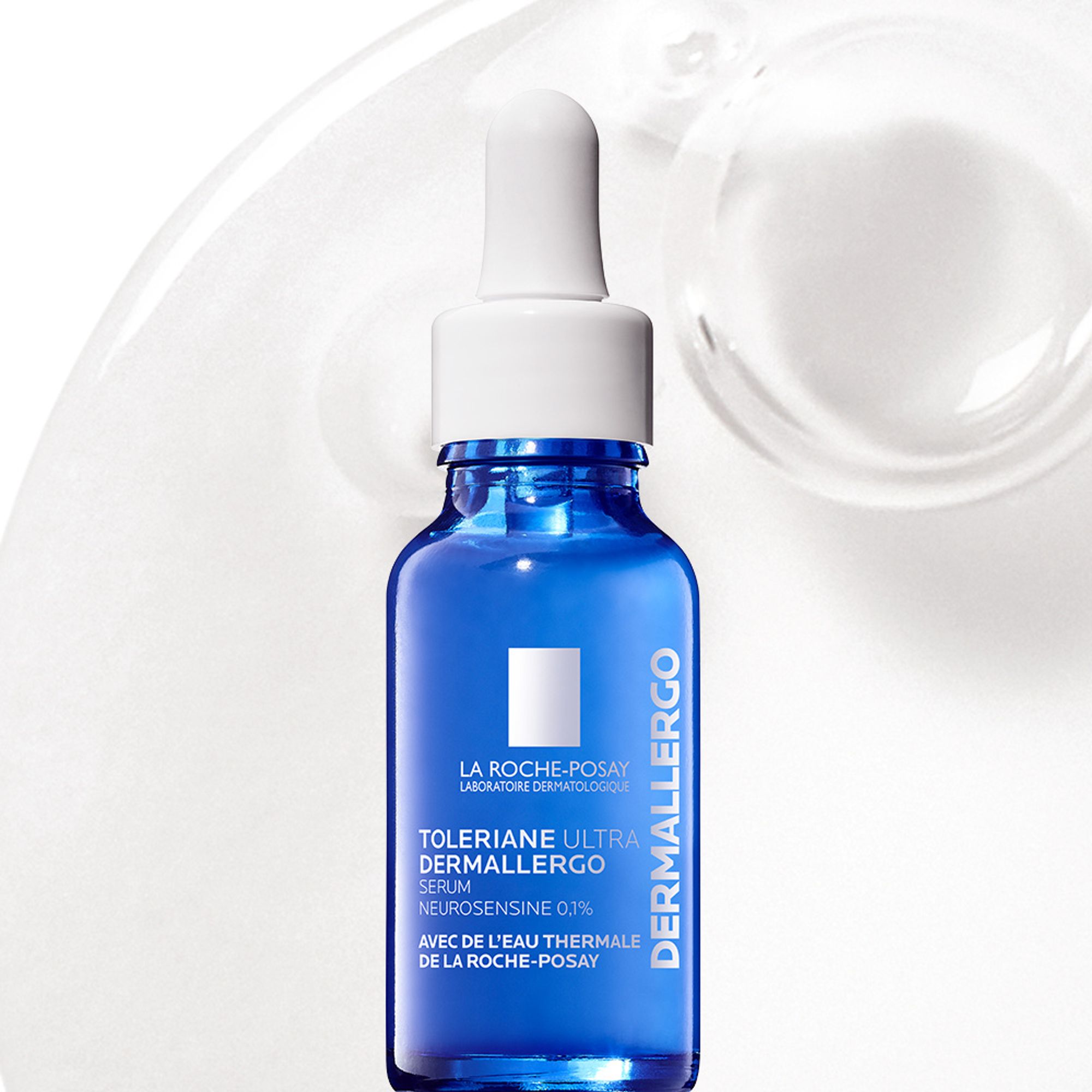 Toleriane Ultra Dermallergo Serum in front of a close-up texture shot of a clear serum