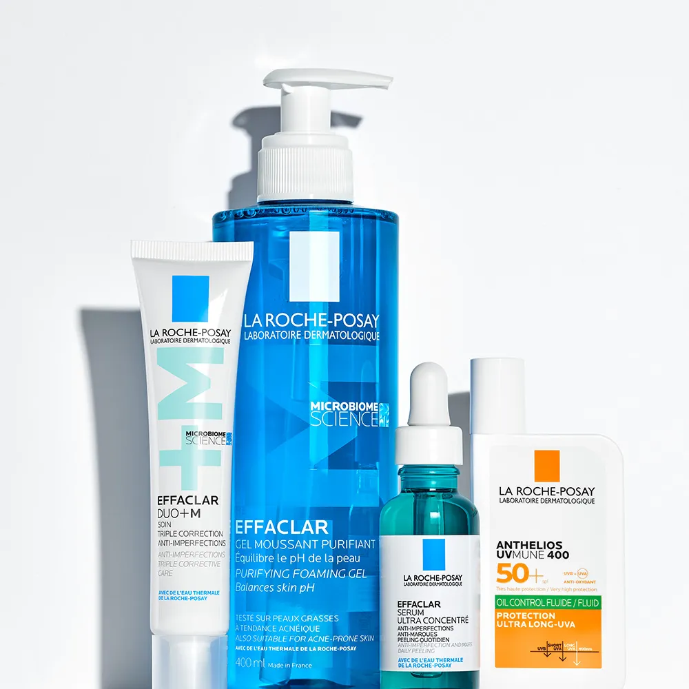 Two hands holding Effaclar Purifying Cleansing Gel & Effaclar Duo+M