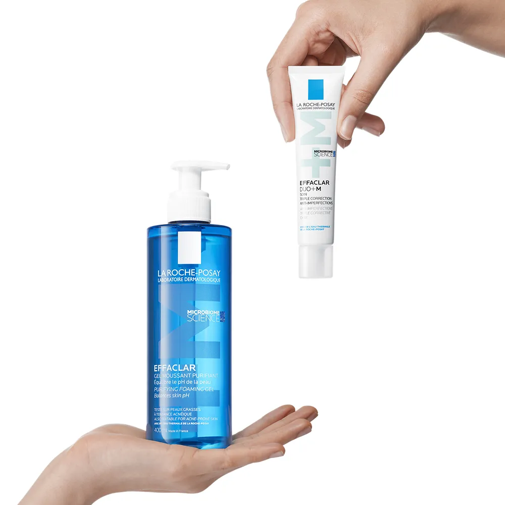 Two hands holding Effaclar Purifying Cleansing Gel & Effaclar Duo+M